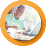 a man smiling looking at his laptop