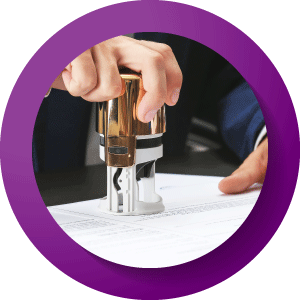 A person stamping a piece of paper.