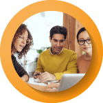 three people surrounding a laptop looking at it 